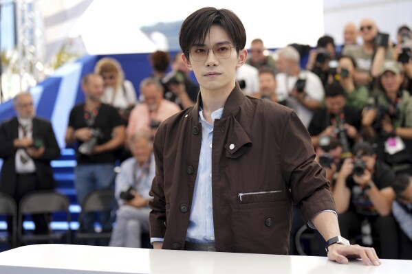 Jackson Yee poses for photographers at the photo call for the film "Resurrection" at the 78th international film festival in Cannes, southern France, Friday, May 23, 2025. (AP Photo/Natacha Pisarenko)