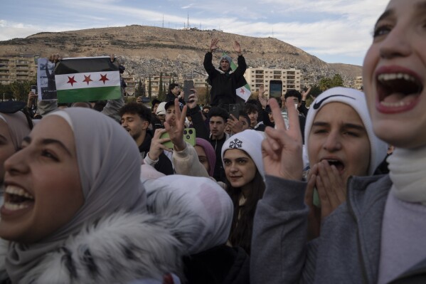 People gather to celebrate days after the fall of Bashar Assad's government at Umayyad Square in Damascus, Thursday, Dec. 12, 2024. (AP Photo/Leo Correa, File)