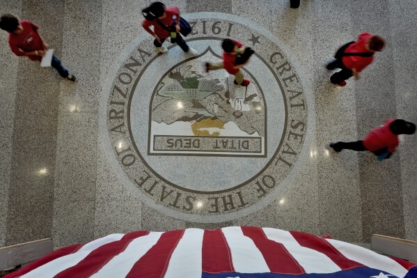 People walk to the Senate gallery to watch the proceedings, Wednesday, May 1, 2024, at the Capitol in Phoenix. Democrats secured enough votes in the Arizona Senate to repeal a Civil War-era ban on abortions that the state's highest court recently allowed to take effect. (AP Photo/Matt York)