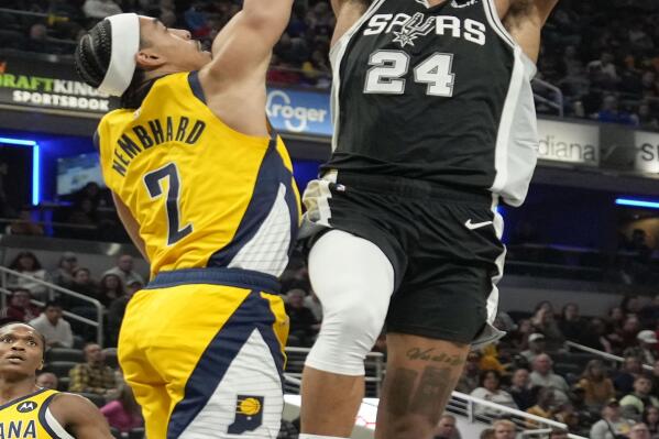 San Antonio Spurs guard Devin Vassell (24) shoots over Indiana Pacers guard Andrew Nembhard (2) during the first half of an NBA basketball game in Indianapolis, Friday, Oct. 21, 2022. (AP Photo/AJ Mast)