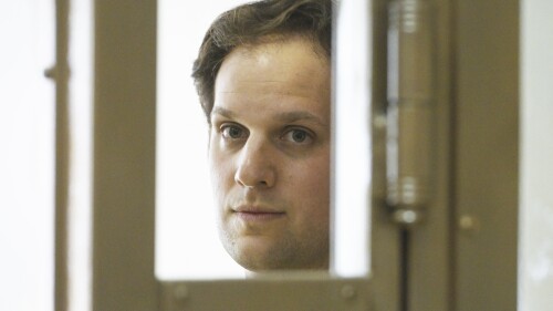 FILE - Wall Street Journal reporter Evan Gershkovich stands in a glass cage in a courtroom at the Moscow City Court in Moscow, Russia, June 22, 2023. (AP Photo/Dmitry Serebryakov, File)