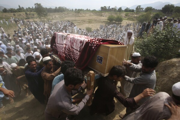 Relatives and mourners carry the casket of a victim killed in Sunday's suicide bomber attack in the Bajur district of Khyber Pakhtunkhwa, Pakistan, Monday, July 31, 2023. Pakistan held funerals on Monday for victims of a massive suicide bombing that targeted a rally of a pro-Taliban cleric the previous day. (AP Photo/Mohammad Sajjad)