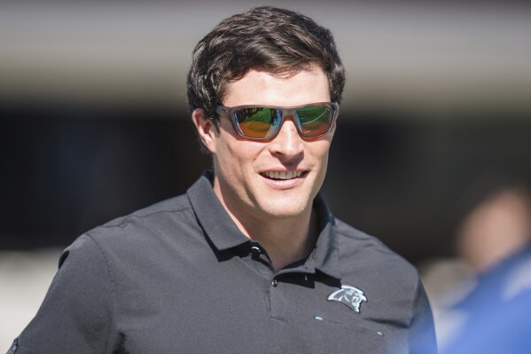 Former Carolina Panthers linebacker Luke Kuechly watches warm ups before an NFL football game between the Carolina Panthers and the Tampa Bay Buccaneers Sunday, Oct. 23, 2022, in Charlotte, N.C. (AP Photo/Jacob Kupferman, File)