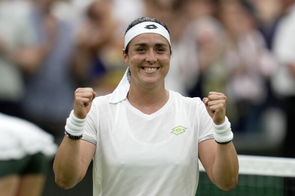 Tunisia's Ons Jabeur celebrates winning against Aryna Sabalenka of Belarus during their women's semifinal singles match on day eleven of the Wimbledon tennis championships in London, Thursday, July 13, 2023. (AP Photo/Kin Cheung)