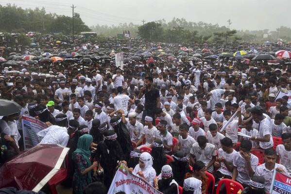 Hundreds of Rohingyas gather in the rain to demand safe return to Myanmar's Rakhine state as they mark the seventh anniversary of their mass exodus from Myanmar at their refugee camp at Kutupalong in Cox's Bazar district, Bangladesh, Sunday, Aug. 25, 2024. (AP Photo/ Shafiqur Rahman)