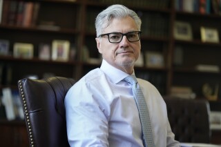 Judge Juan M. Merchan sits for a portrait in his chambers in New York, March 14, 2024. (AP Photo/Seth Wenig, File)