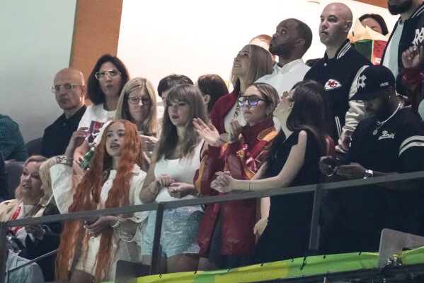 Ice Spice, from left, Taylor Swift, Este Haim, Alana Haim and Ashley Avignone, back center, watch during the first half of the NFL Super Bowl 59 football game between the Kansas City Chiefs and the Philadelphia Eagles, Sunday, Feb. 9, 2025, in New Orleans. (AP Photo/Gerald Herbert)