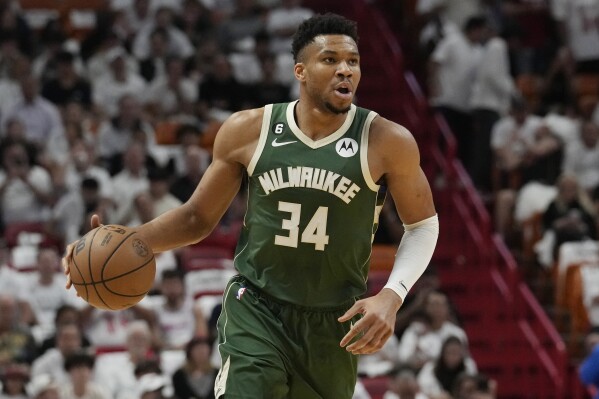 FILE - Milwaukee Bucks forward Giannis Antetokounmpo (34) dribbles the ball during the first half of Game 4 in a first-round NBA basketball playoff series against the Miami Heat in Miami, Monday, April 24, 2023. Antetokounmpo said Friday, Aug. 11 that he will not be able to play for Greece at the World Cup that starts in two weeks because of ongoing recovery from knee surgery. (AP Photo/Marta Lavandier, File)