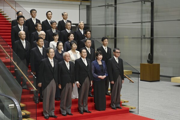 Japanese Prime Minister Fumio Kishida, center, bottom row, poses with his new cabinet members in Tokyo, Japan, Wednesday, Sept. 13, 2023, after a cabinet reshuffle. (David Mareuil/Pool Photo via AP)