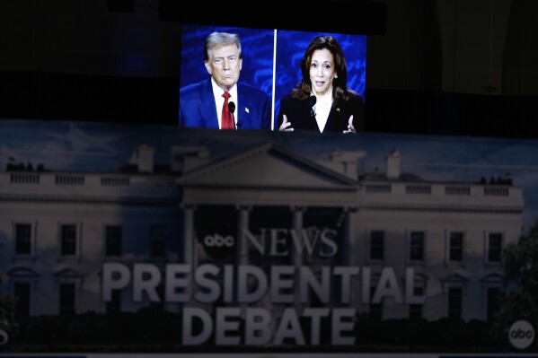 A presidential debate between Republican presidential nominee former President Donald Trump, on screen at left, and Democratic presidential nominee Vice President Kamala Harris, right, is seen from the spin room, Tuesday, Sept. 10, 2024, in Philadelphia. (AP Photo/Matt Slocum)