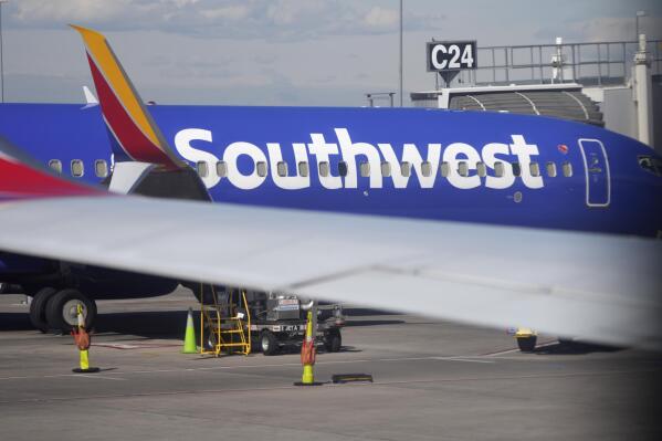 FILE - A Southwest Airlines jetliner sits at a gate on the C concourse of Denver International Airport on Wednesday, Oct. 6, 2021, in Denver.  A Southwest Airlines pilot is suing the company, her union and a former colleague who pleaded guilty last year to stripping naked in front of her during a flight, Wednesday, Oct. 5, 2022. C(AP Photo/David Zalubowski)