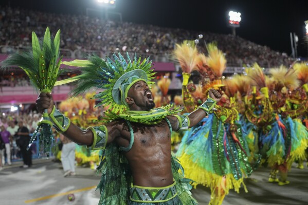 Performers from the Viradouro samba school parade during Carnival celebrations at the Sambadrome in Rio de Janeiro, Monday, March 3, 2025. (AP Photo/Silvia Izquierdo)