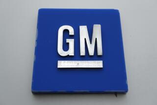 FILE - A General Motors logo is displayed outside the General Motors Detroit-Hamtramck Assembly plant on Jan. 27, 2020, in Hamtramck, Mich. General Motors is making some performance-related job cuts, Wednesday, March 1, 2023, among some of its salaried employees and executives. The Detroit automaker did not specify how many jobs would be eliminated, but did say it would impact a relatively small number of workers. (AP Photo/Paul Sancya, File)