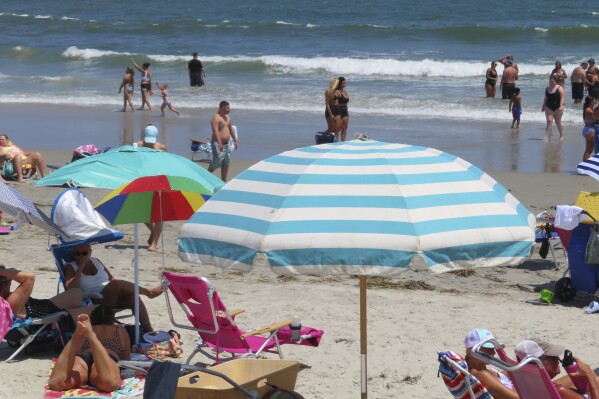 Beachgoers enjoy the sand and surf in North Wildwood N.J. on July 7, 2023. (AP Photo/Wayne Parry)