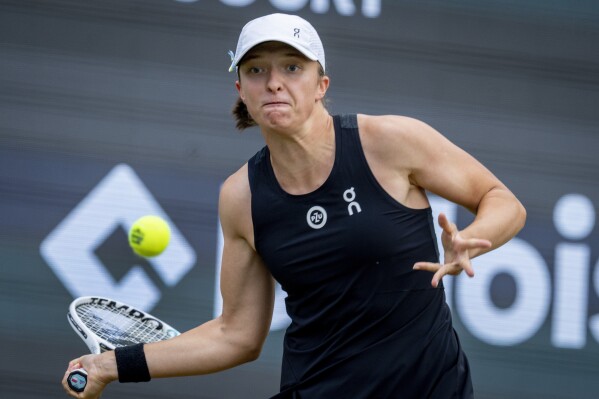 Poland's Iga Swiatek hits a forehand to Switzerland's Jil Teichmann during their match at the WTA tennis tournament in Bad Homburg, Germany, Wednesday, June 28, 2023. (AP Photo/Michael Probst)