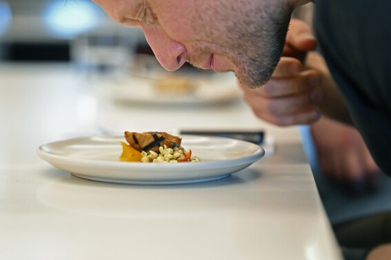Dave Pirazzini smells cultivate chicken before sampling it at GOOD Meat's Alameda, Calif., headquarters on Thursday, Sept. 28, 2024. The company's cultivated chicken, which is grown from animal cells, is APproved for sale in the United States and Singapore. (AP Photo/Noah Berger)