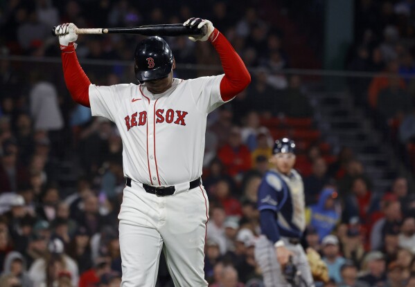 Boston Red Sox designated hitter Rafael Devers reacts after striking out as Tampa Bay Rays catcher Danny Jansen looks on during the seventh inning of a baseball game at Fenway Park, Monday, June 9, 2025, in Boston. (AP Photo/Mary Schwalm)