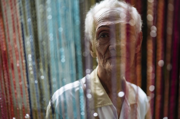 This photo provided by The New York Times shows Al Enriquez, a member of the Golden Gays, is seen in the Home for the Golden Gays, an organisation of elderly gay men in the Philippines who have banded together for social support. On display at the World Press Photo exhibition in Budapest, Hungary in September 2023, this was one of the photos which the government determined was a violation of the law restricting children's access to content that depicts homosexuality or gender change. On Monday, Nov. 6, 2023, Hungary's cultural minister fired Laszlo L. Simon, the director of the Hungarian National Museum, accusing him of failing to comply with a contentious law that bans the display of LGBTQ+ content to minors. (Hannah Reyes Morales for The New York Times via AP)