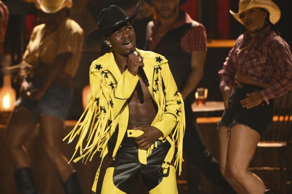 FILE - This June 23, 2019 file photo shows Lil Nas X performing "Old Town Road" at the BET Awards in Los Angeles. The rapper has taken his horse to the old town road and ridden it to the top of the Billboard charts for 16 weeks, tying a record set by Mariah Carey and Luis Fonsi. (Photo by Chris Pizzello/Invision/AP, File)