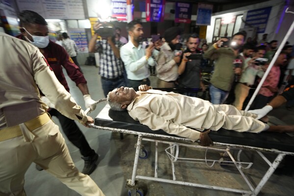 An injured man is brought to the Government Medical College Hospital in Jammu after the bus he was traveling in fell into a deep gorge in the Pouni area of Jammu's Reasi district, India, Sunday, June 9, 2024. Officials in Indian-controlled Kashmir say at least nine people have been killed after suspected militants fired at a bus with Hindu pilgrims, which then fell into a deep gorge. (AP Photo/Channi Anand)