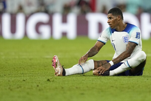 FILE - England's Marcus Rashford sits on the field during the World Cup group B soccer match between England and Wales, at the Ahmad Bin Ali Stadium in Al Rayyan, Qatar, Tuesday, Nov. 29, 2022. Rashford was left out of England’s provisional squad for the European Championship on Tuesday, May 21, 2024. (AP Photo/Abbie Parr, File)