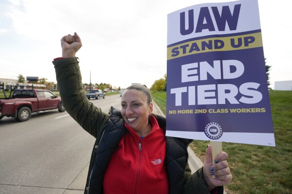 Lence Ristovski, a United Auto Workers member walks the picket line during a strike at the Stellantis Sterling Heights Assembly Plant, in Sterling Heights, Mich., Monday, Oct. 23, 2023. (AP Photo/Paul Sancya)