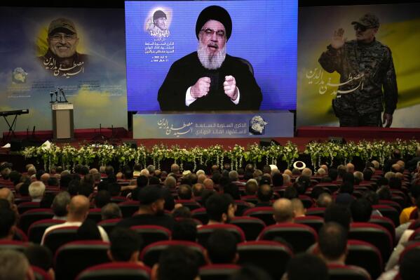 Hezbollah leader Sayyed Hassan Nasrallah addresses a speech via a video link, during a ceremony to mark the seven anniversary death of Hezbollah slain top commander Mustafa Badreddine, in the southern suburbs of Beirut, Lebanon, Friday, May 12, 2023. Nasrallah denied Friday reports that linked one of Syria's most well-known drug dealers who was killed earlier this week in an airstrike near the Jordanian border to the Iran-backed group calling such accusations "baseless lies." (AP Photo/Hussein Malla)