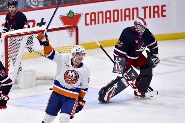 New York Islanders Bo Horvat (14) celebrates his short-handed goal against Winnipeg Jets goaltender David Rittich (33) during the first period of an NHL hockey game in Winnipeg, Manitoba, on Sunday, Feb, 26, 2023. (Fred Greenslade/The Canadian Press via AP)