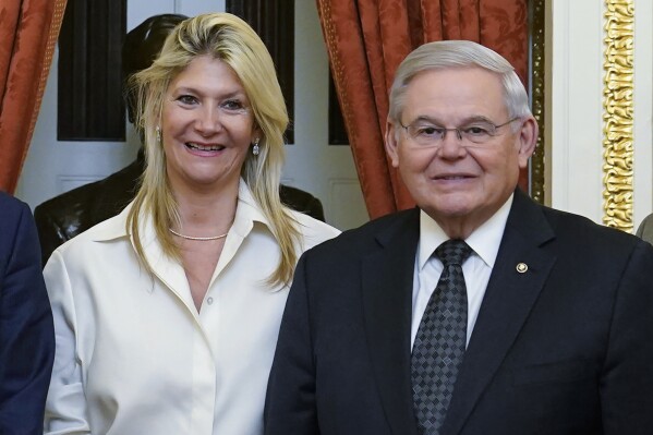 FILE - Senate Foreign Relations Committee Chairman, Sen. Bob Menendez, D-N.J., right, and his wife Nadine Arslanian, pose for a photo on Capitol Hill in Washington, Dec. 20, 2022. Arslanian, the then-future wife of Sen. Menendez, killed a man with her car in December 2018 and was sent from the scene without being charged, according to new details that match an auto “accident” that prosecutors cite in their sweeping federal indictment of the pair as a pivotal motivation for one of the senator's alleged bribes. (AP Photo/Susan Walsh, File)