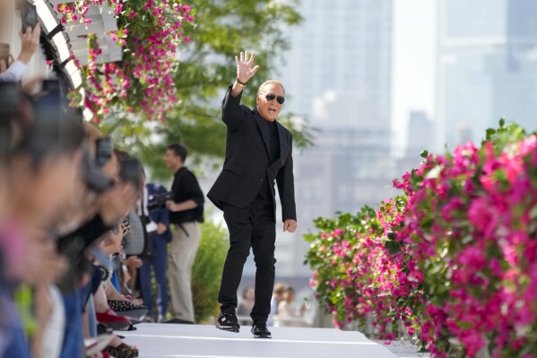 Designer Michael Kors acknowledges the audience applause after his collection was modeled during Fashion Week, Monday, Sept. 11, 2023, in New York. (AP Photo/Mary Altaffer)