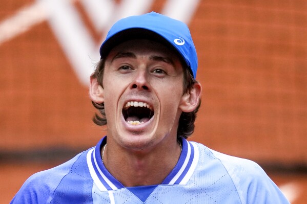 Australia's Alex De Minaur celebrates winning his fourth round match of the French Open tennis tournament against Russia's Daniil Medvedev at the Roland Garros stadium in Paris, Monday, June 3, 2024. (AP Photo/Christophe Ena)