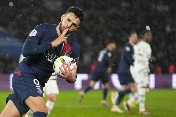 PSG's Goncalo Ramos celebrates after scoring his side's opening goal from penalty spot during the French League One soccer match between Paris Saint-Germain and Rennes, at the Parc des Princes stadium in Paris, France, Sunday, Feb. 25, 2024. (AP Photo/Michel Euler)