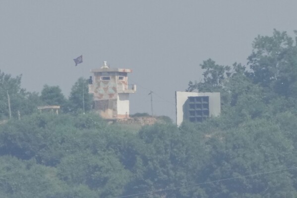 A North Korean military guard post, left, and loudspeaker are seen from Paju, South Korea, near the border with North Korea, Thursday, June 12, 2025. (AP Photo/Ahn Young-joon)