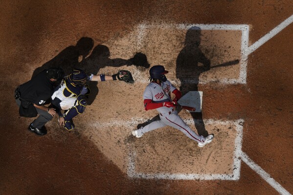 Washington Nationals' CJ Abrams hits into a double play during the eighth inning of a baseball game against the Milwaukee Brewers Sunday, Sept. 17, 2023, in Milwaukee. (AP Photo/<orry Gash)