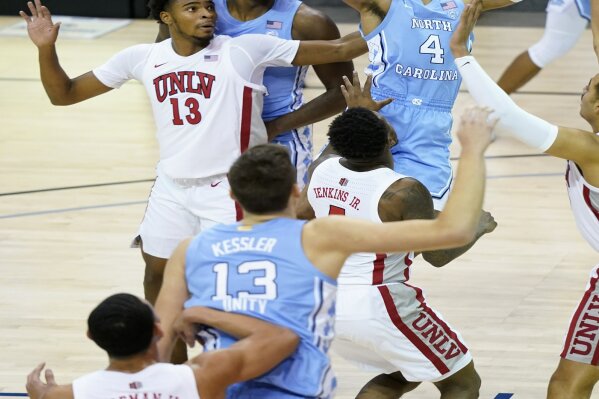 North Carolina guard R.J. Davis (4) leaps to shoot a basket over UNLV guard Bryce Hamilton (13) in the first half of an NCAA college basketball game in the Maui Invitational tournament, Monday, Nov. 30, 2020, in Asheville, N.C. (AP Photo/Kathy Kmonicek)