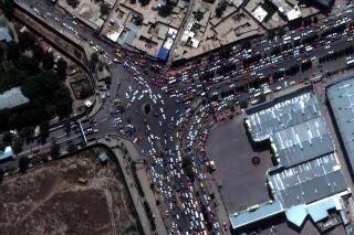 This satellite image provided by Maxar Technologies shows crowds and traffic at the entrance to Kabul’s international airport on Monday, Aug. 23, 2021. (Satellite Image ©2021 Maxar Technologies via AP)