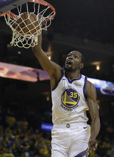 FILE - In this April 13, 2019, file photo, then-Golden State Warriors' Kevin Durant scores against the Los Angeles Clippers in the second half in Game 1 of a first-round NBA basketball playoff series in Oakland, Calif. Kevin Durant is finally within weeks of suiting up for the Brooklyn Nets. Sidelined last season while recovering from surgery on his Achilles tendon, he begins training camp this week on a team that can contend for the NBA title if he can be as good as he was before his injury. (AP Photo/Ben Margot, File)