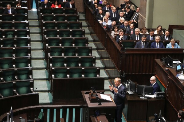 Poland's Prime Minister Donald Tusk addresses the Polish parliament on Wednesday, June 11, 2025, in Warsaw, Poland. (AP Photo/Czarek Sokolowski)