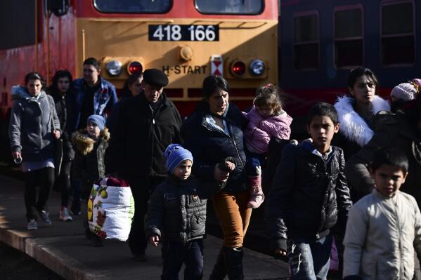 FILE - Refugees fleeing conflict from neighboring Ukraine arrive to Zahony, Hungary, Sunday, Feb. 27, 2022. As hundreds of thousands of Ukrainians seek refuge in neighboring countries, cradling children in one arm and clutching belongings in the other, leaders in Poland, Hungary, Bulgaria, Moldova and Romania are offering a hearty welcome. (AP Photo/Anna Szilagyi, File)