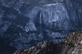 In this Saturday, June 12, 2021, photo provided by Scott Oller Films, highliner Daniel Monterrubio walks the 2,800-foot-long line off Taft Point above Yosemite Valley in Yosemite, Calif. (Scott Oller/Scott Oller Films via AP)