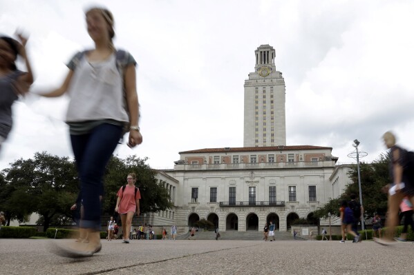 In this Sept. 27, 2012, file photo, students walk through the University of Texas at Austin campus near the school's iconic tower in Austin, Texas. (AP Photo/Eric Gay, File)