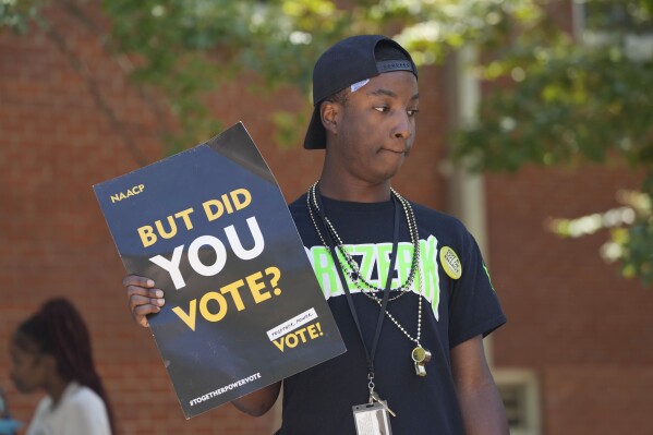 FILE - A Jackson State University student holds a sign stressing the importance of voting during a JSU Votes Civic Engagement Initiative on National Voter Registration Day, Sept. 19, 2023, on the Jackson, Miss., campus. According to information from the Mississippi Secretary of State's Office, the number of registered voters in the state has remained steady during the months leading to the Nov. 7 election for governor and other offices. (AP Photo/Rogelio V. Solis, File)