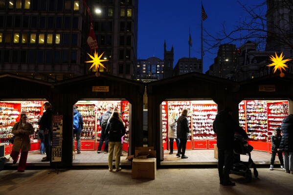 FILE - Shoppers visit the Christmas Village in Philadelphia, Dec. 13, 2023. On Wednesday, the Commerce Department releases U.S. retail sales data for December. (AP Photo/Matt Rourke, File)