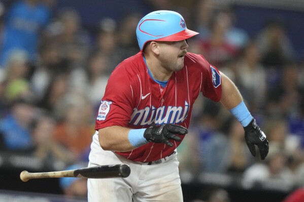 Miami Marlins' Jake Burger tosses his bat after hitting a two-run home run during the eighth inning of a baseball game against the Atlanta Braves, Saturday, Sept. 16, 2023, in Miami. (AP Photo/Lynne Sladky)