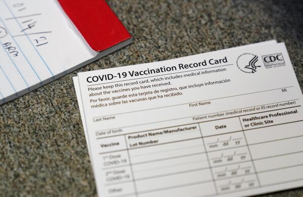 FILE - In this Dec. 24, 2020, file photo, a COVID-19 vaccination record card is shown at Seton Medical Center in Daly City, Calif. California is offering residents to access a digital record of their coronavirus vaccinations they can use to access businesses or events that require proof of inoculation. The state's public health and technology departments said Friday, June 18, 2021, the new tool will allow Californians to access their record from the state's immunization registry. (AP Photo/Jeff Chiu, File)
