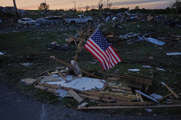 An American flag is posted near destroyed homes after a tornado passed through the area on May 17, 2025, in London, Ky. (AP Photo/Carolyn Kaster, File)