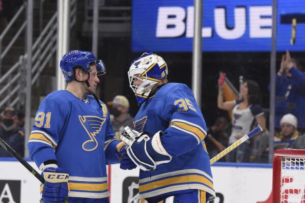 St. Louis Blues right wing Vladimir Tarasenko (91) and goaltender Ville Husso (35) celebrate the team's victory over the Chicago Blackhawks in an NHL hockey game Saturday, Feb. 12, 2022, in St. Louis. (AP Photo/Joe Puetz)