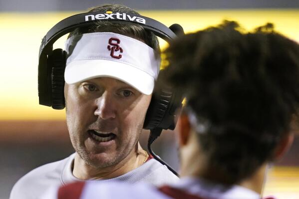 Southern California coach Lincoln Riley speaks with quarterback Caleb Williams during the first half of the team's NCAA college football game against Utah on Saturday, Oct. 15, 2022, in Salt Lake City. (AP Photo/Rick Bowmer)