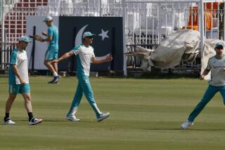Australia's Mitchell Marsh, left, Mitchell Starc, center, and Josh Hazlewood, left, warm up prior to practice session at the Pindi Stadium in Rawalpindi, Pakistan, Wednesday, March 2, 2022. Pakistan and Australia cricket teams will play first test match on March 4. (AP Photo/Anjum Naveed)