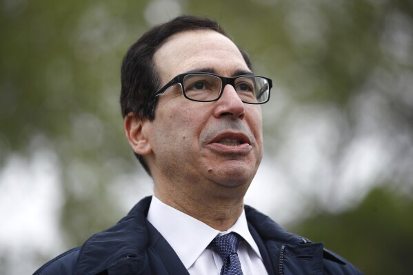 FILE - Former Treasury Secretary Steve Mnuchin speaks to reporters outside the White House March 29, 2020 in Washington.  Mnuchin says he will form an investor group to buy TikTok, a day after the House of Representatives passed a bill that would ban the popular video app in the US if the China-based owner does not sell its stake.  (AP Photo/Patrick Semansky, file)